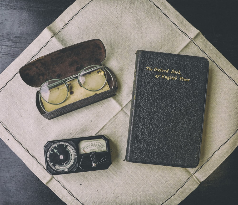 black framed eyeglasses on black leather case