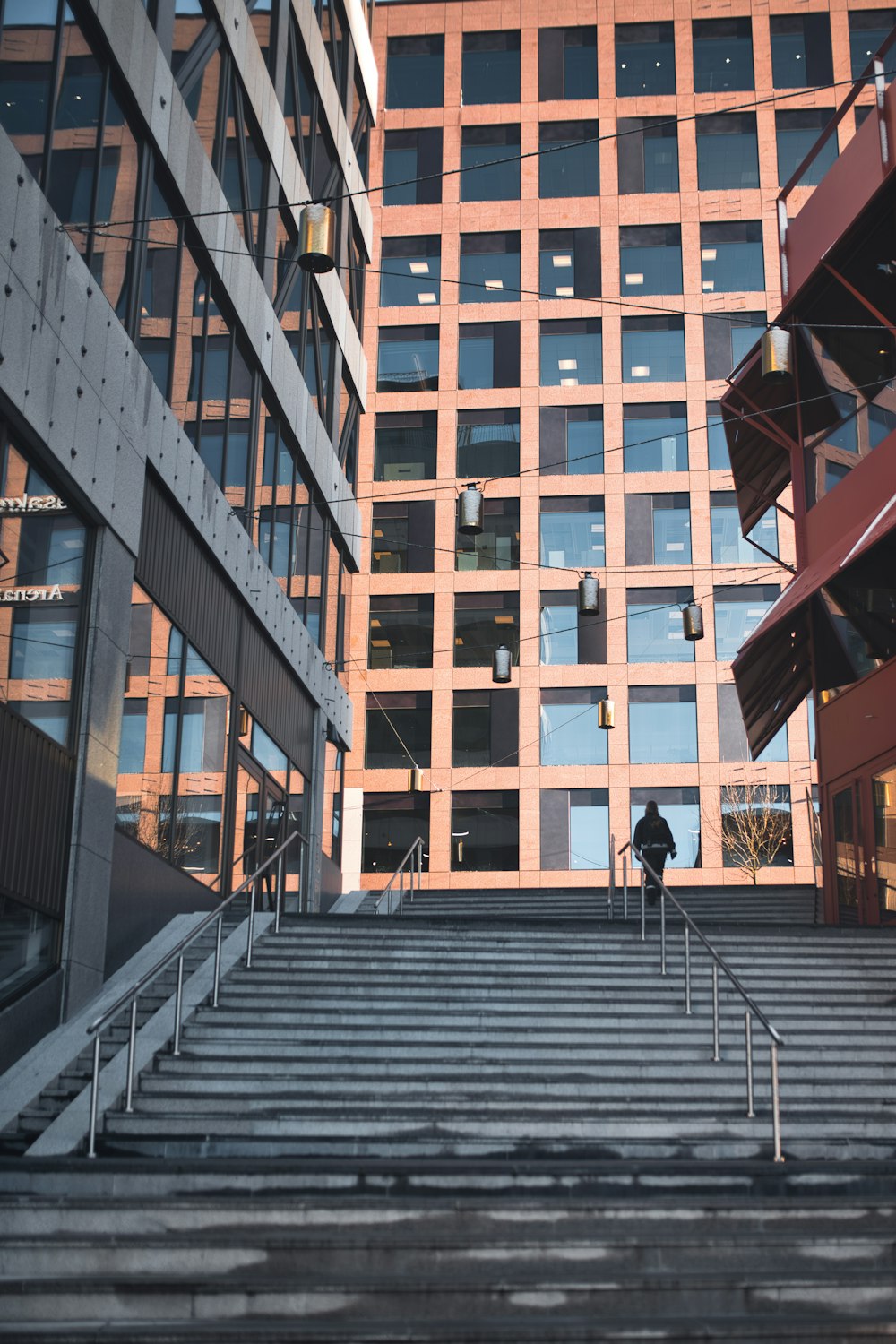 man in black jacket walking on gray concrete stairs