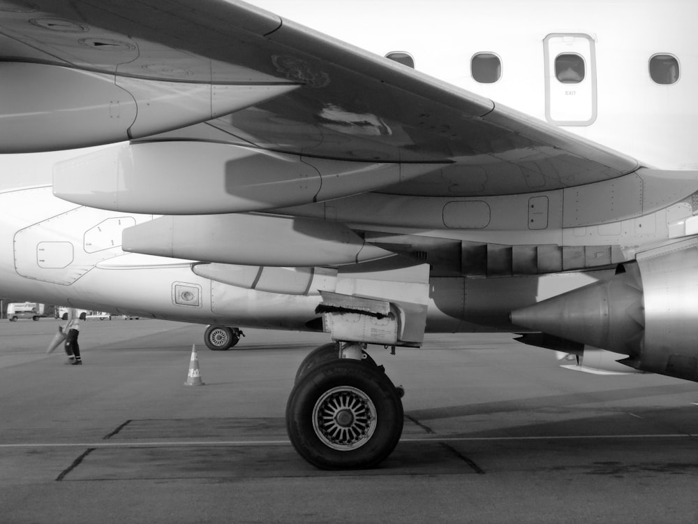 gray and white airplane on gray concrete ground