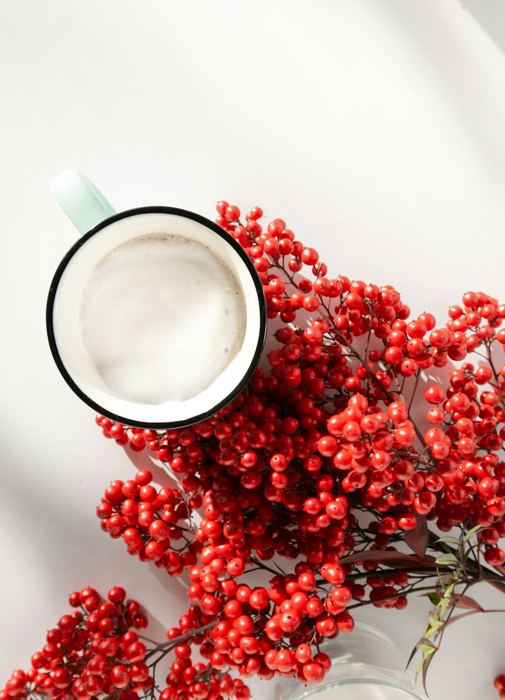 white and red ceramic mug with coffee