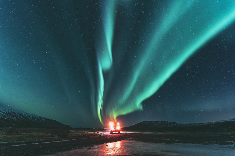 green light in the sky during night time