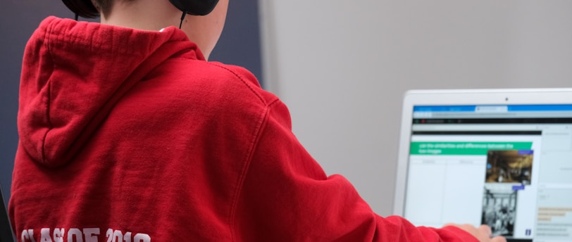 boy in red hoodie wearing black headphones