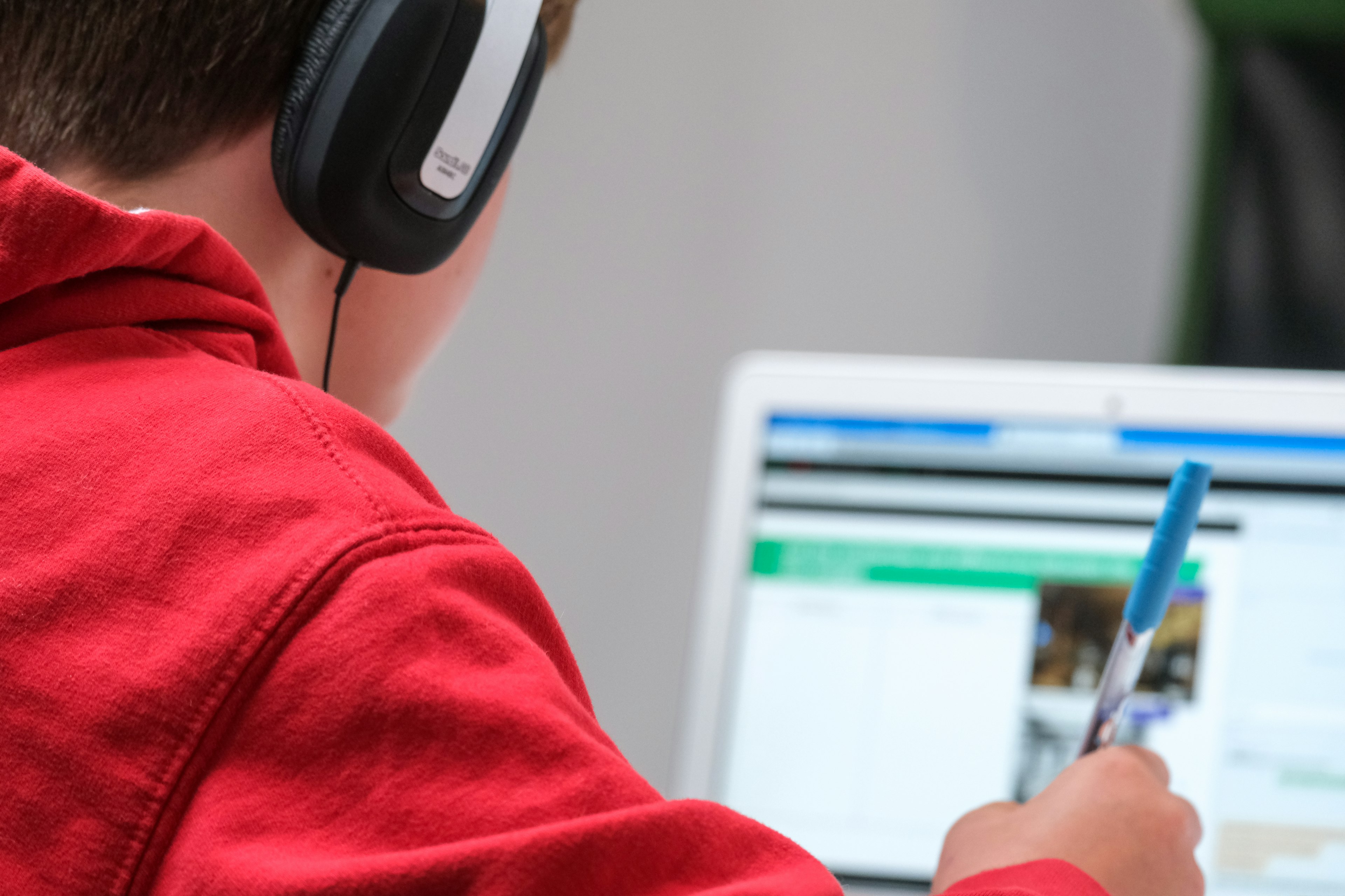 Person wearing headphones as he studies for his theory test