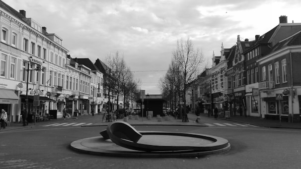 An aesthetic black and white street photo capturing a quiet moment in Vilnius with soft shadows.