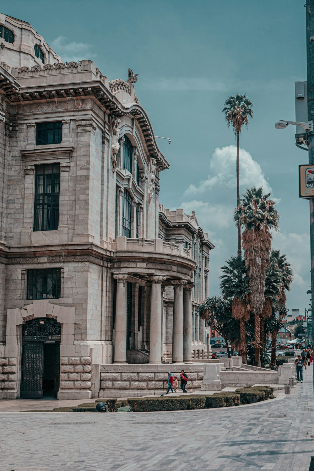 brown concrete building near green trees during daytime