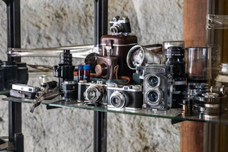black and silver camera on glass shelf