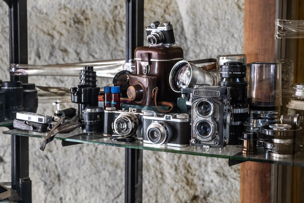 black and silver camera on glass shelf