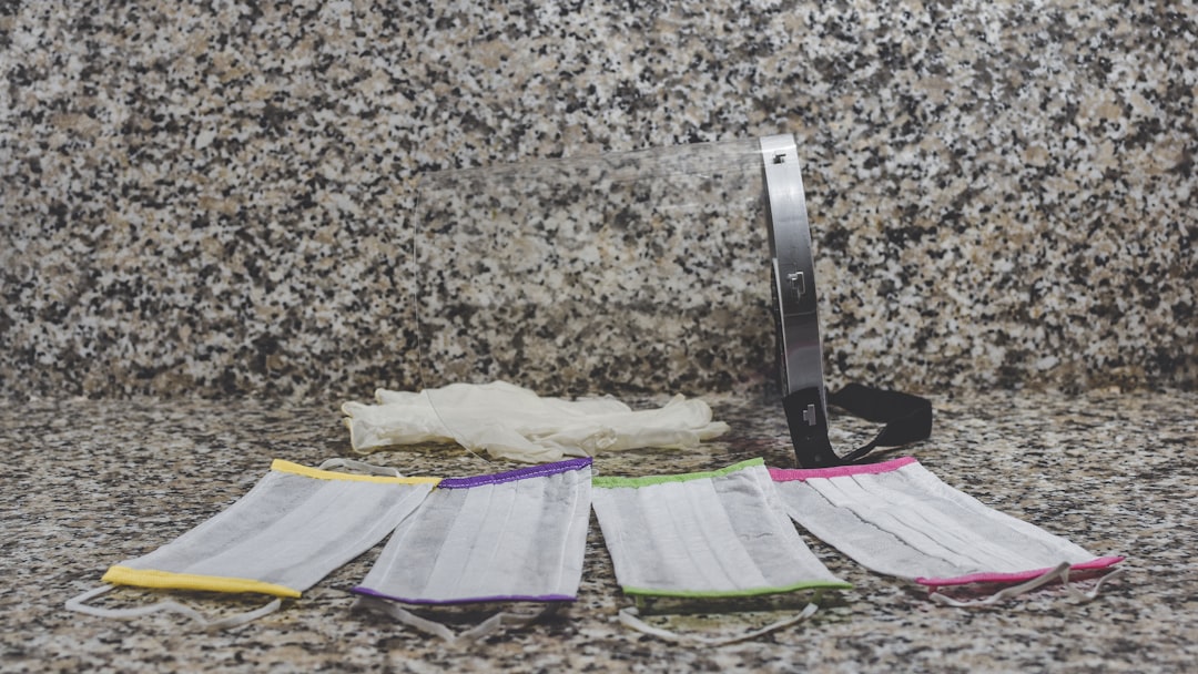 picture of medical masks and a specimen cup on a granite countertop