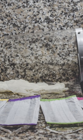 purple and white textile on brown and black marble table