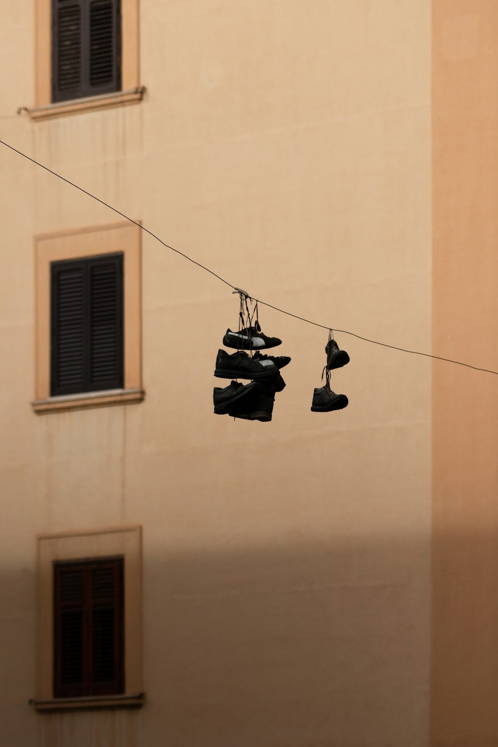 black and white clothes hanger on brown concrete wall