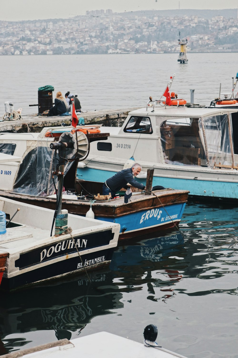 white and blue boat on water