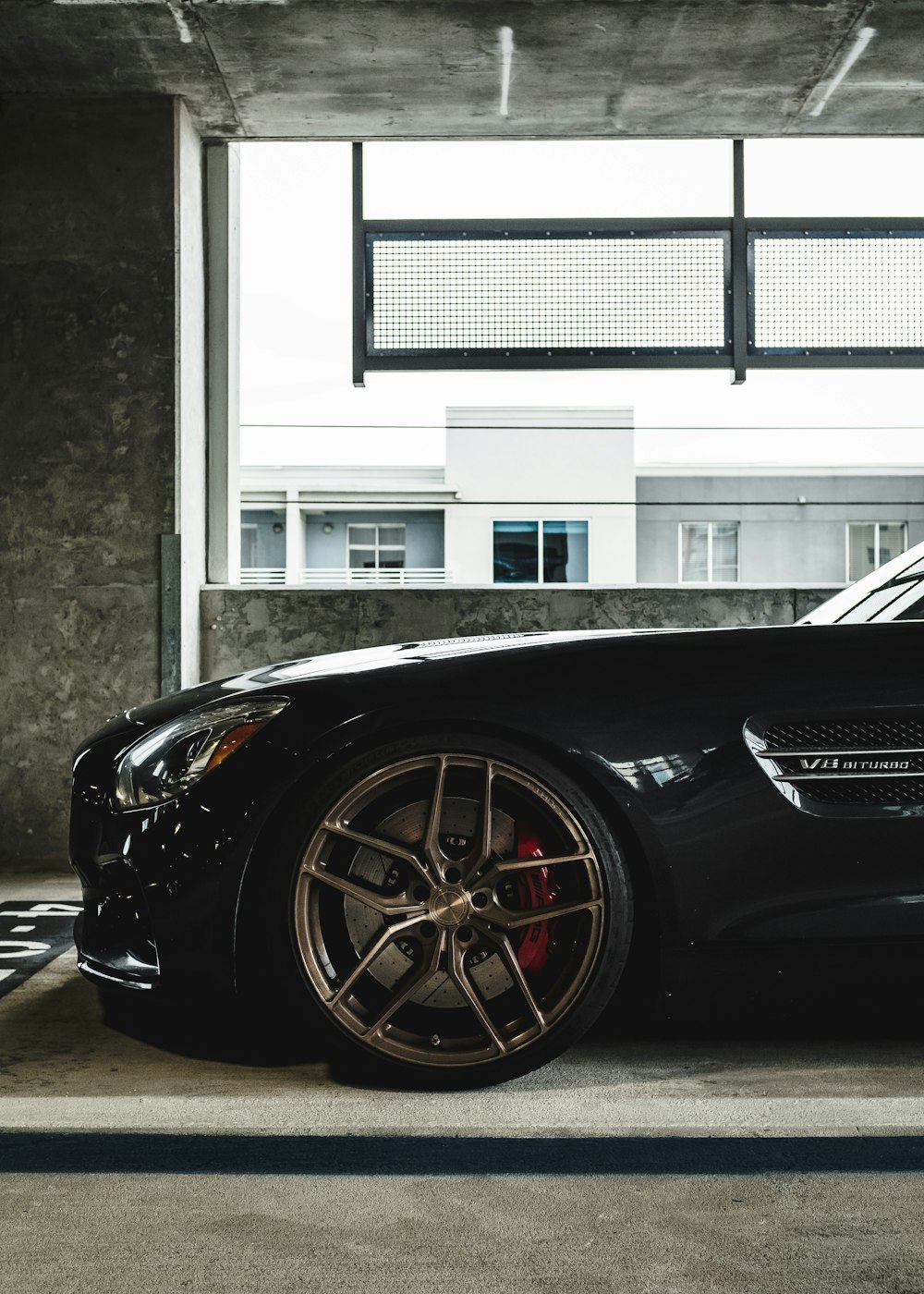 black car parked in front of white building