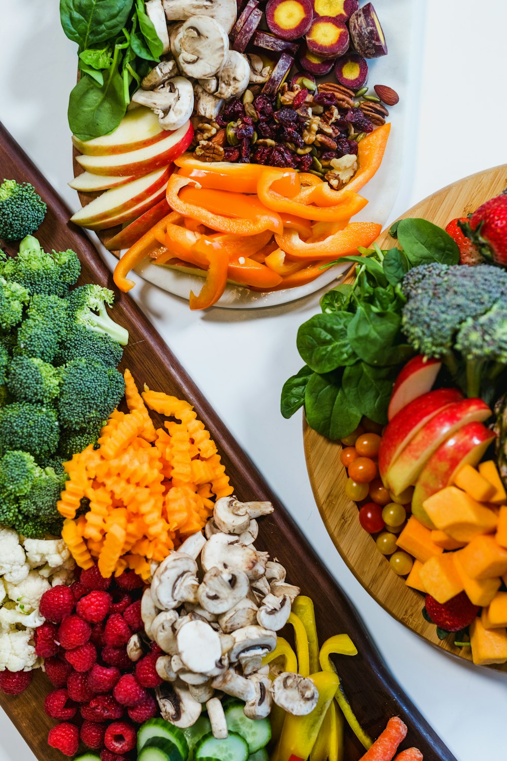 sliced carrots and broccoli on brown wooden tray