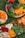 A vibrant display of assorted fresh fruits and nuts on a wooden table.