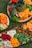 A vibrant display of assorted fresh fruits and nuts on a wooden table.