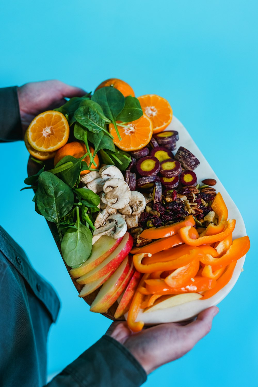 sliced carrots and green leaves on white ceramic plate