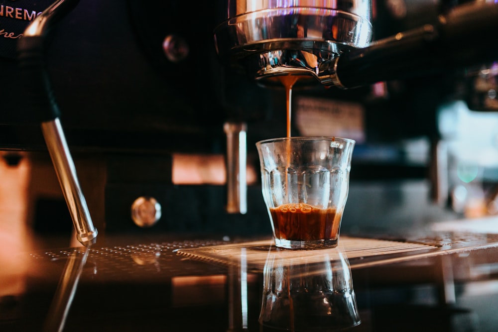 clear glass cup with brown liquid