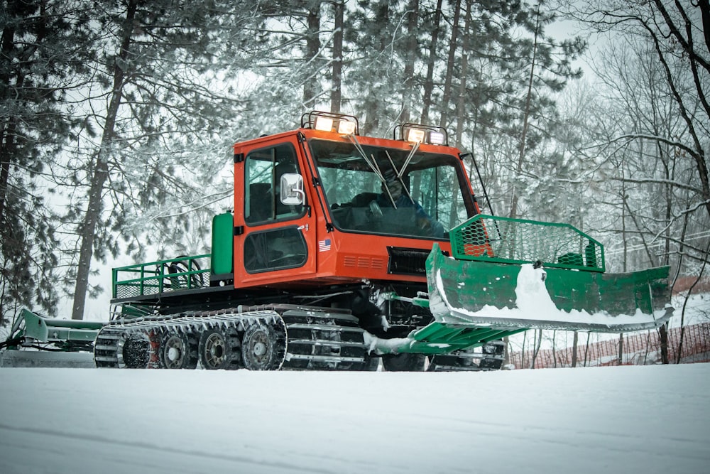 green and brown tractor on snow covered ground during daytime