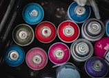 A collection of paint cans in various colors.