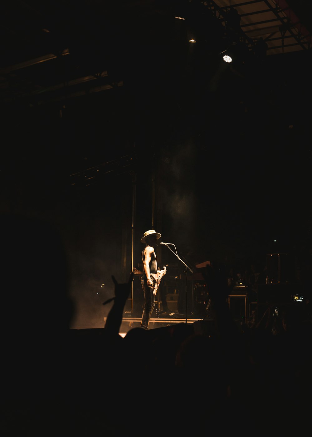 man in black t-shirt singing on stage