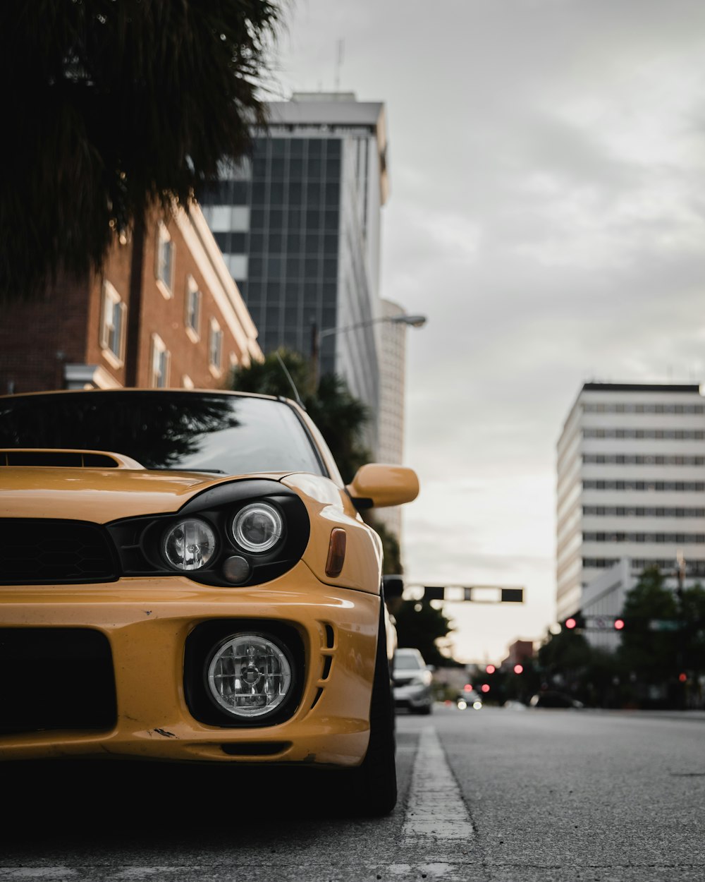 yellow porsche 911 parked on street during daytime