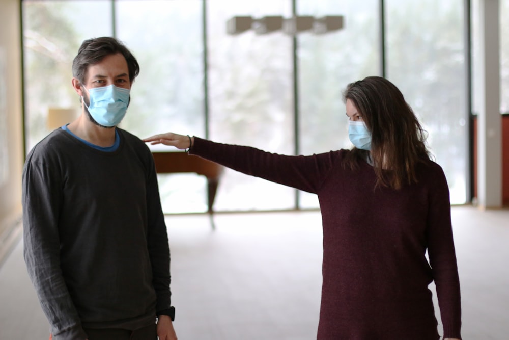 woman in maroon long sleeve shirt wearing white mask