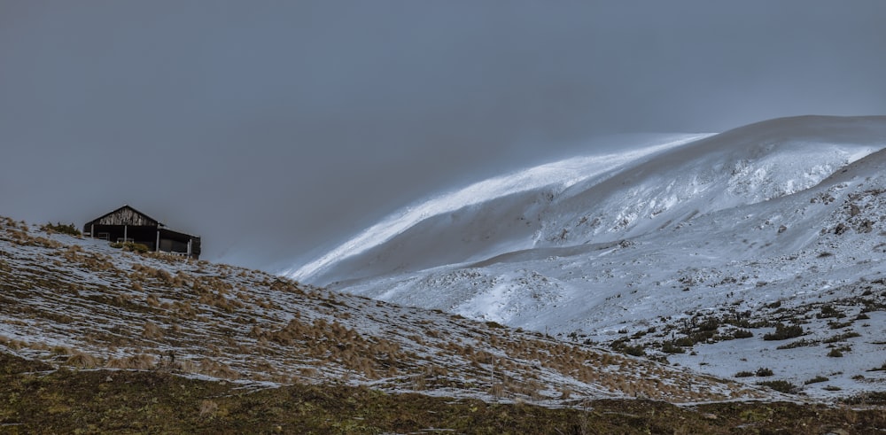 snow covered mountain under gray sky