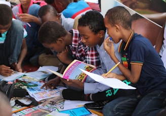 boy in blue and white plaid shirt reading book