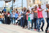 group of people standing on street during daytime