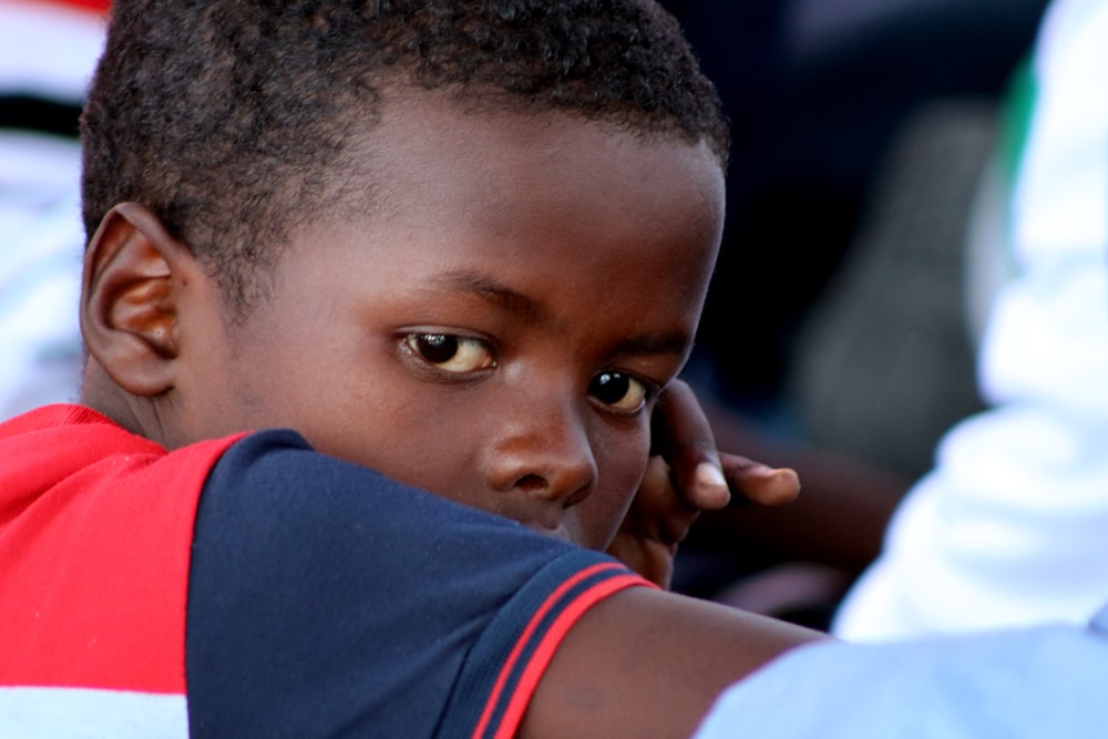 boy in white and blue shirt