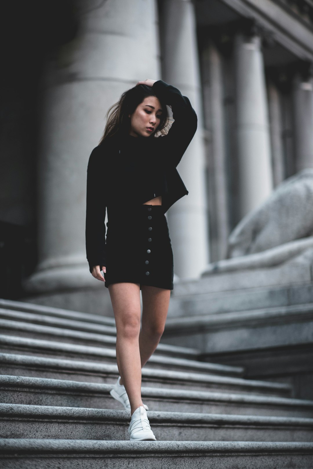 woman in black long sleeve dress standing on stairs