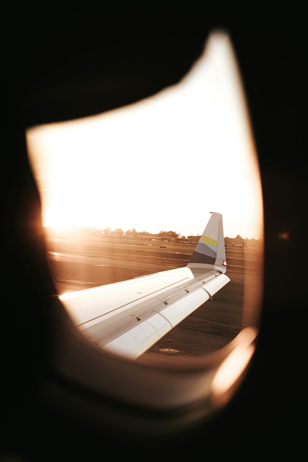 white airplane wing during sunset