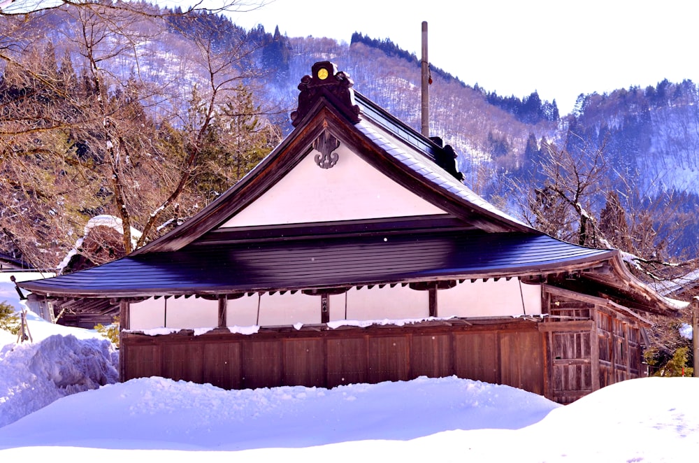 brown wooden house on snow covered ground