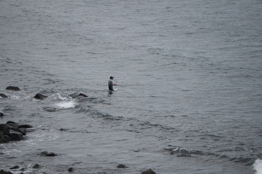 2 person surfing on sea during daytime