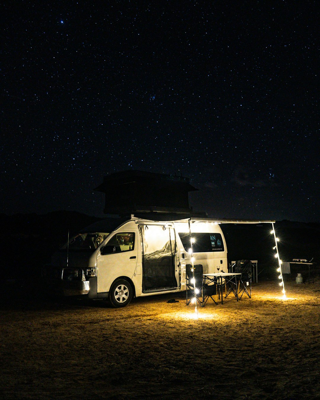 white van on brown field during night time