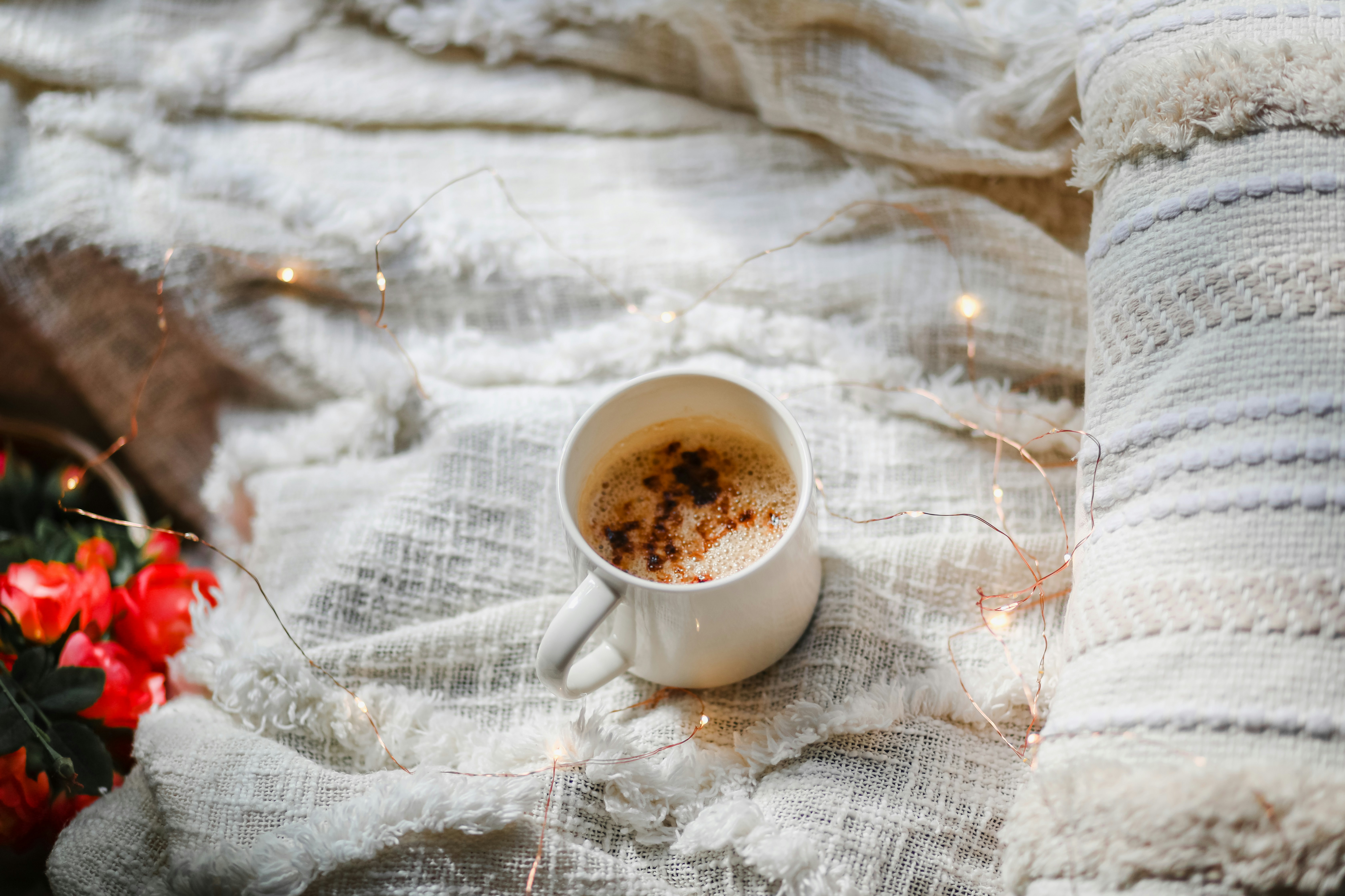 White ceramic mug on white ceramic saucer