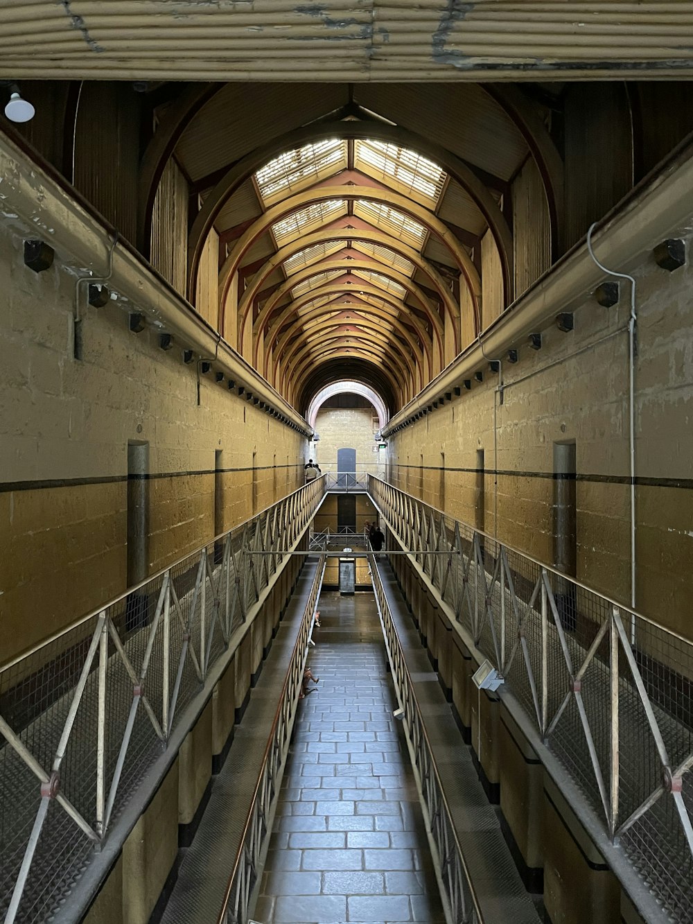 white and brown hallway with white metal railings