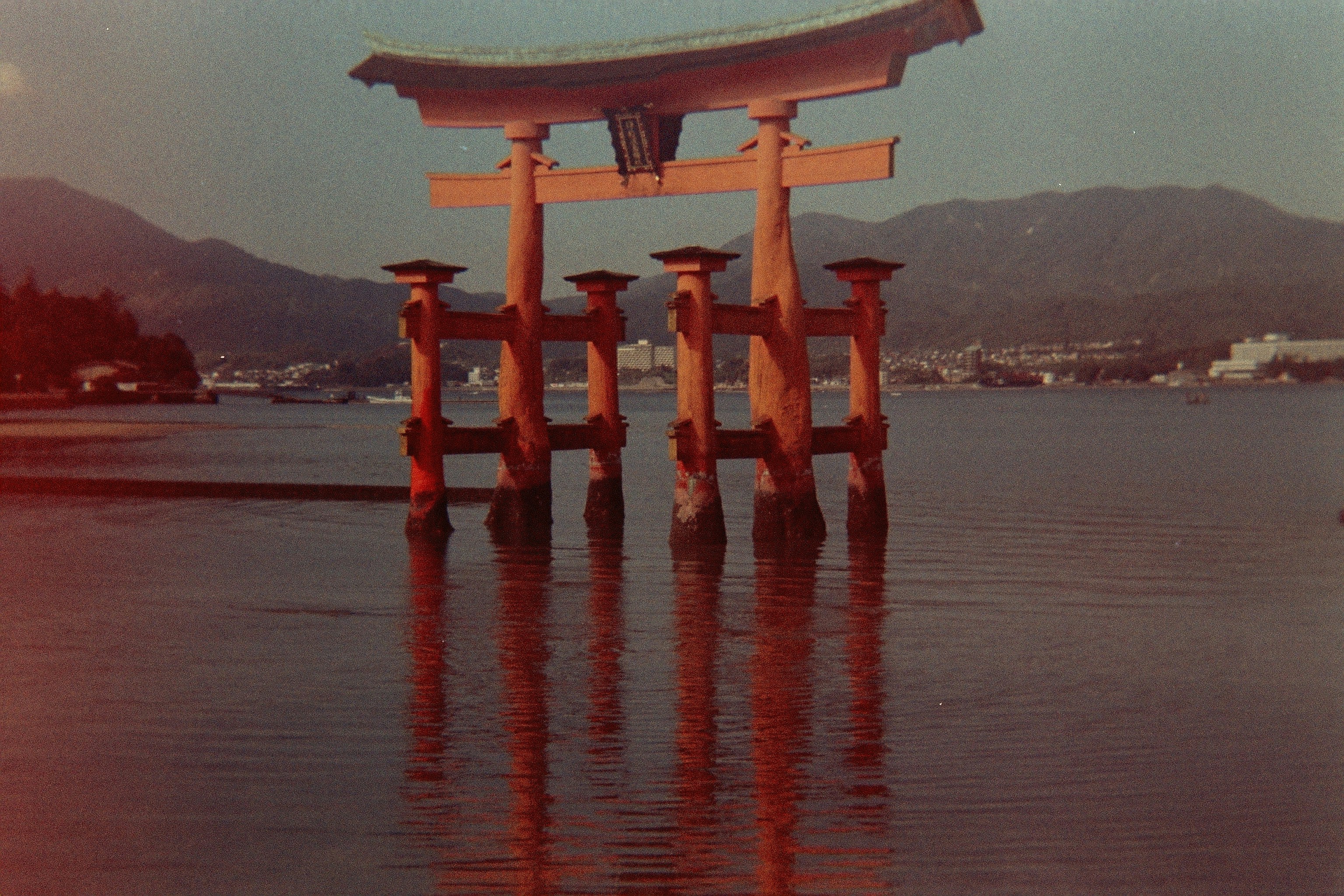 red and brown concrete post on body of water