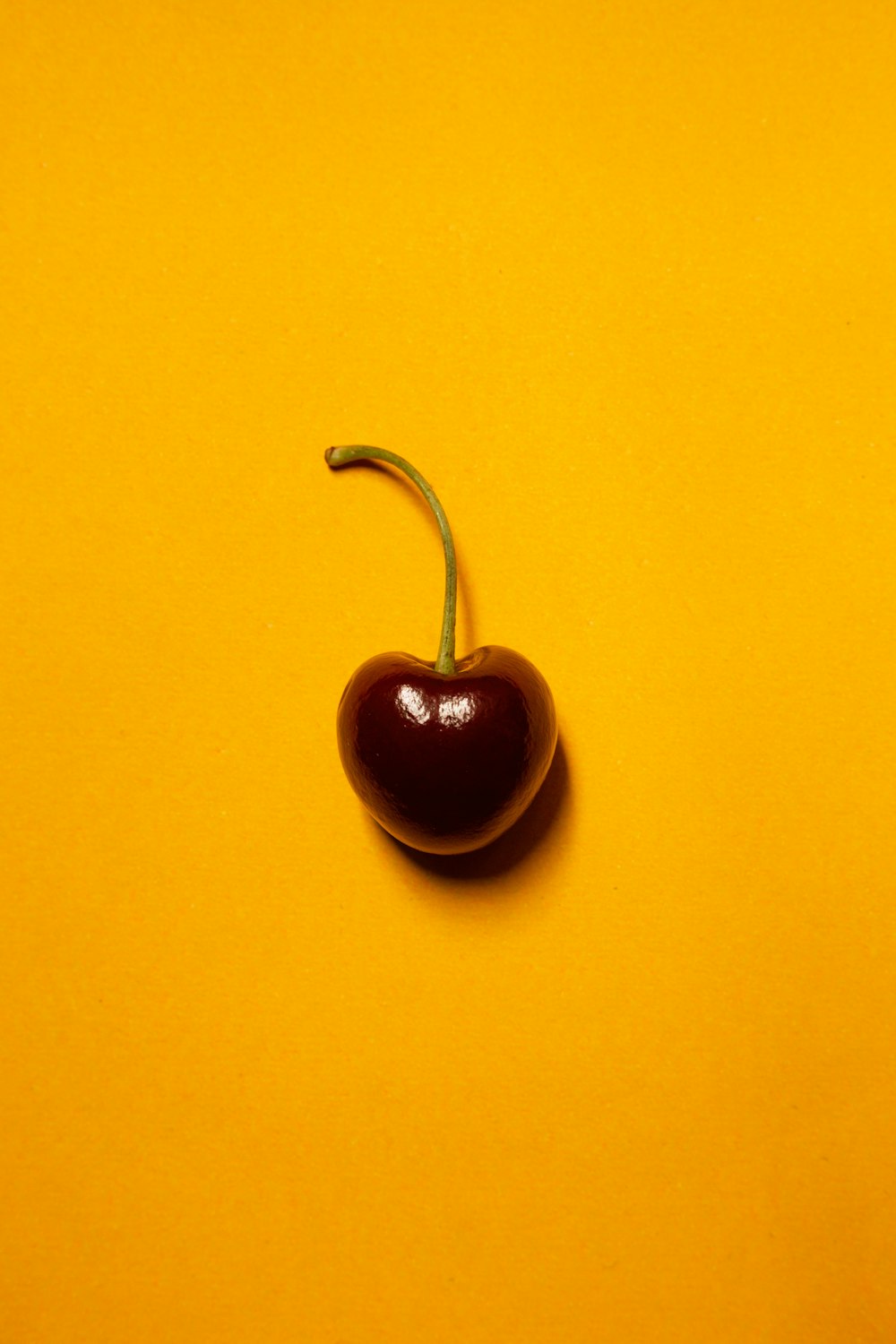 red heart shaped pendant on yellow surface