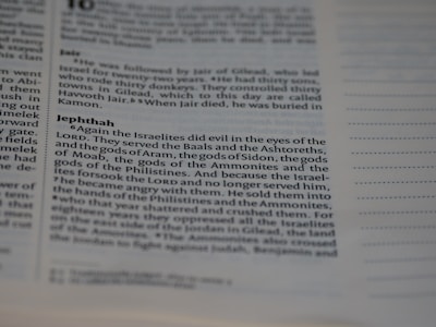 A close-up view of a page from a religious text, with a focus on a passage about Jephthah. The text discusses the Israelites turning to other gods, provoking the anger of the Lord. The font is clear and the surrounding lines provide a structured appearance.