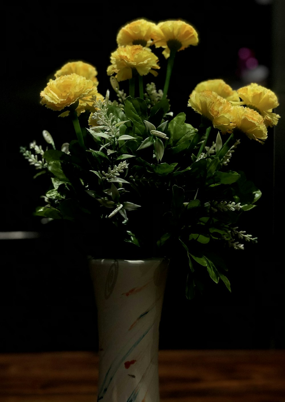 yellow flowers in brown ceramic vase