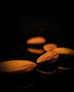 brown almond nuts on black surface