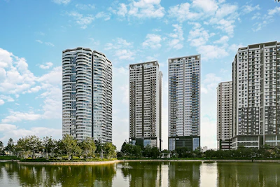 body of water near trees and high rise buildings during daytime