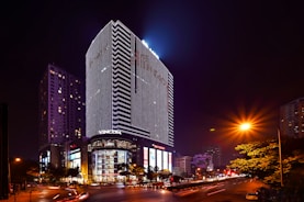 A sleek high-rise tower in Ho Chi Minh City, glowing with evening lights.
