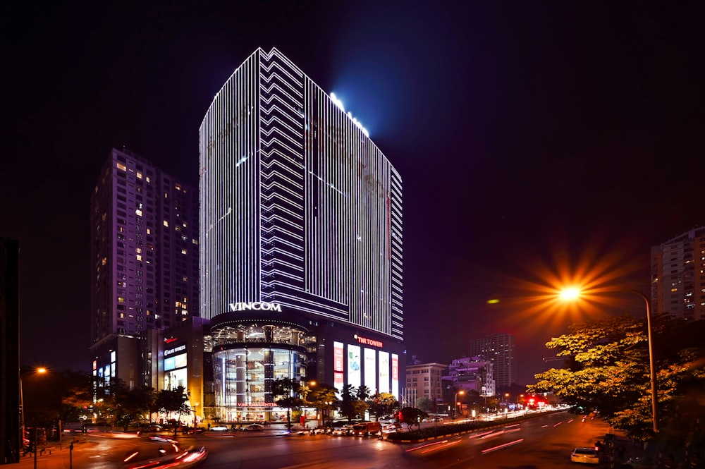 cars on road near high rise building during night time