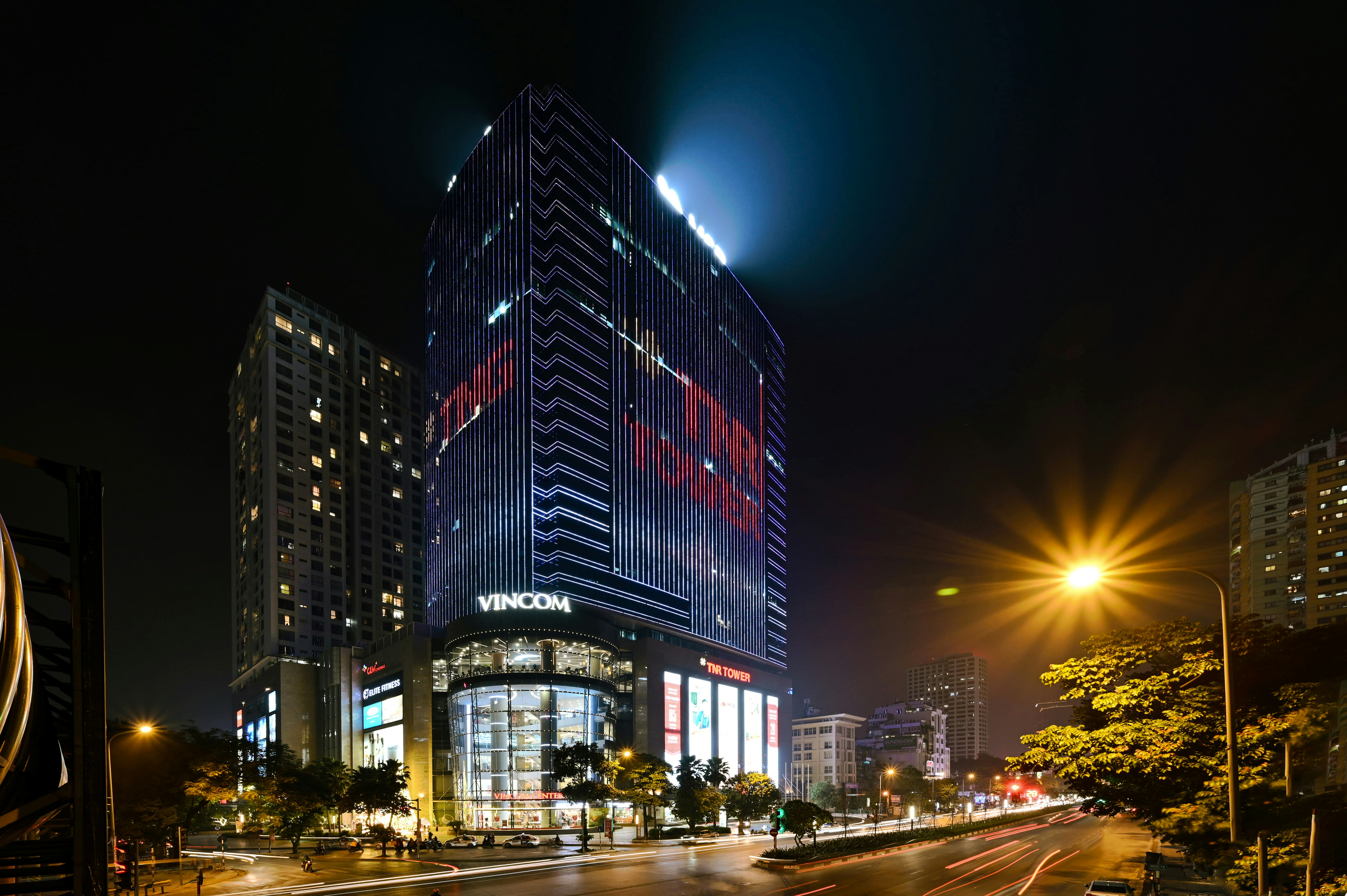 cars on road near high rise building during night time
