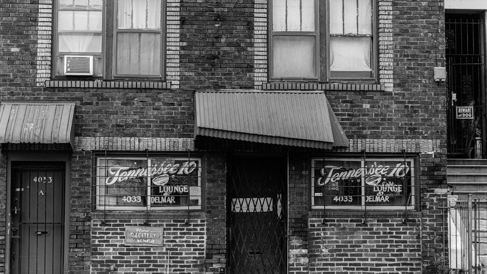 grayscale photo of brick building