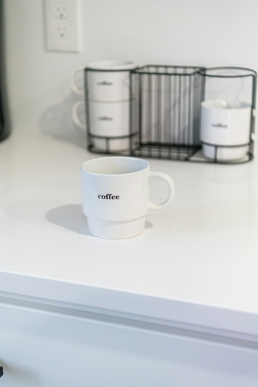 white ceramic mug on white table