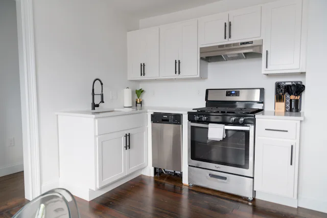 White microwave on a kitchen cabinet similar to Samsung appliances we repair in Somerville
