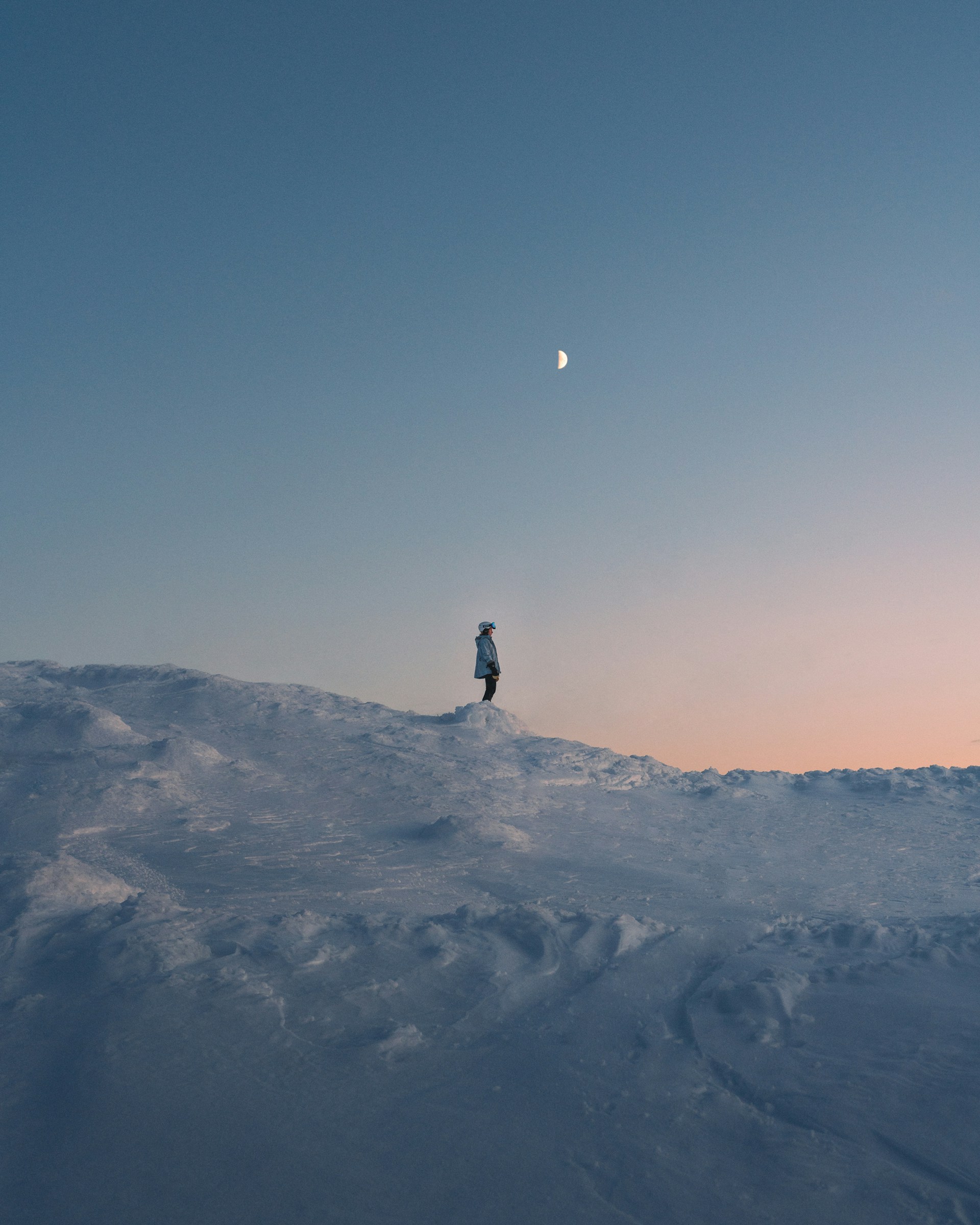 person standing on snow covered mountain during daytime